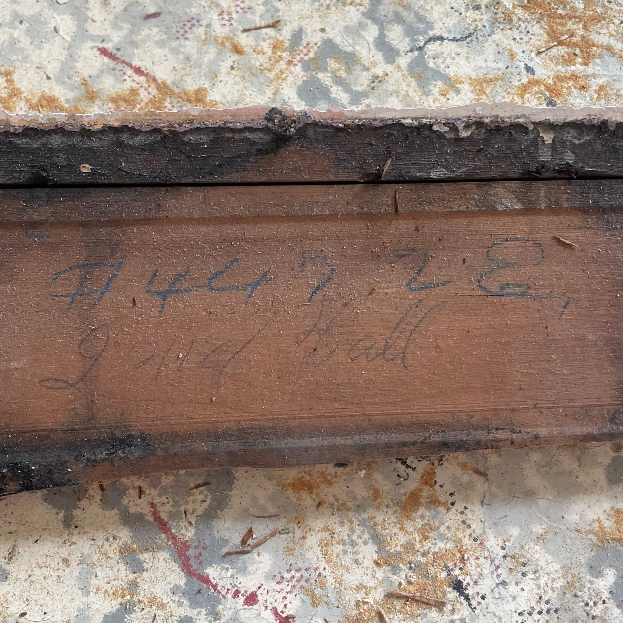 A framing board marked in grease pencil with a kit part number and where it goes