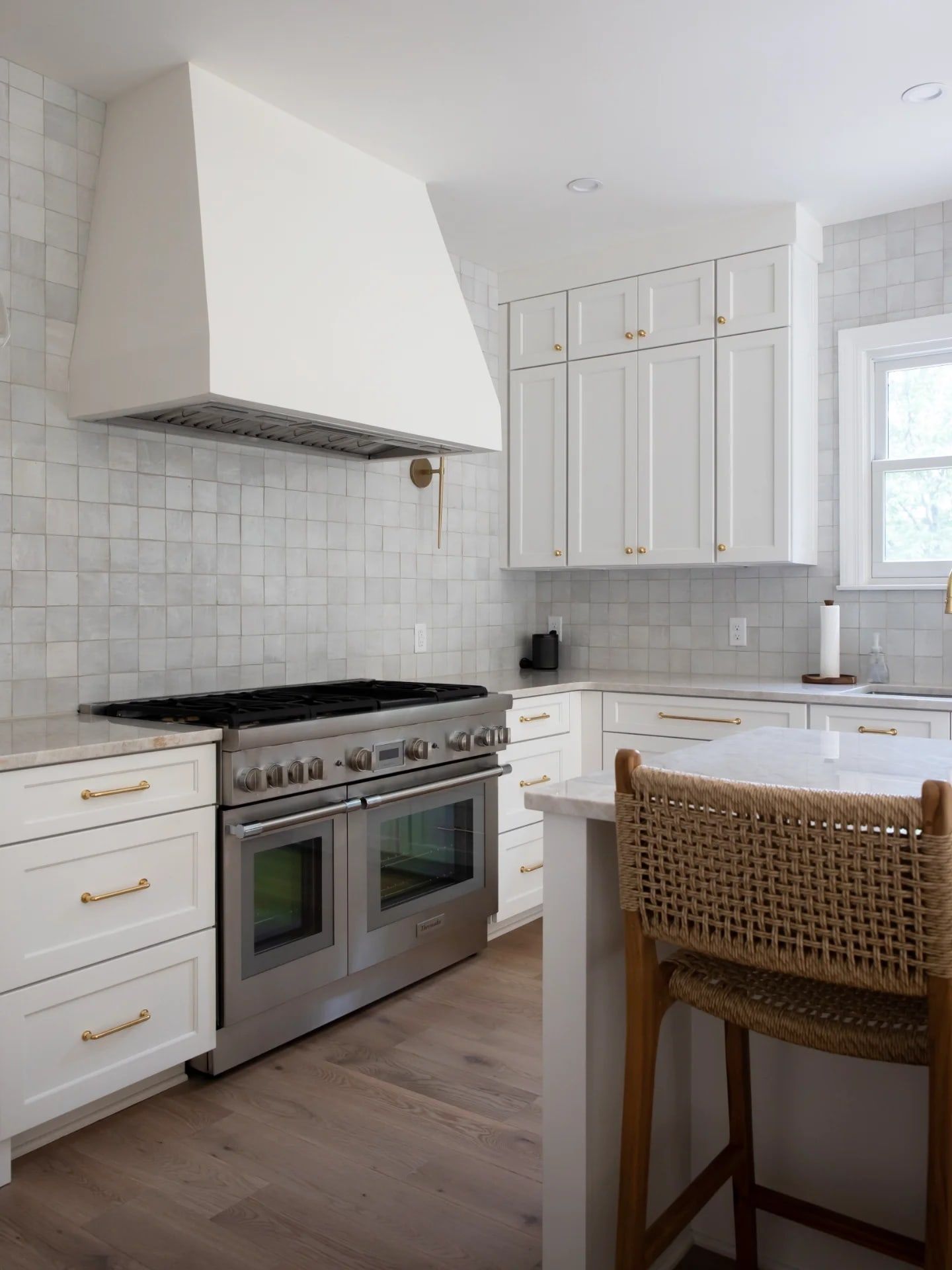 The Franklin Park kitchen: a white plaster hood over the range, with handmade zellige tile