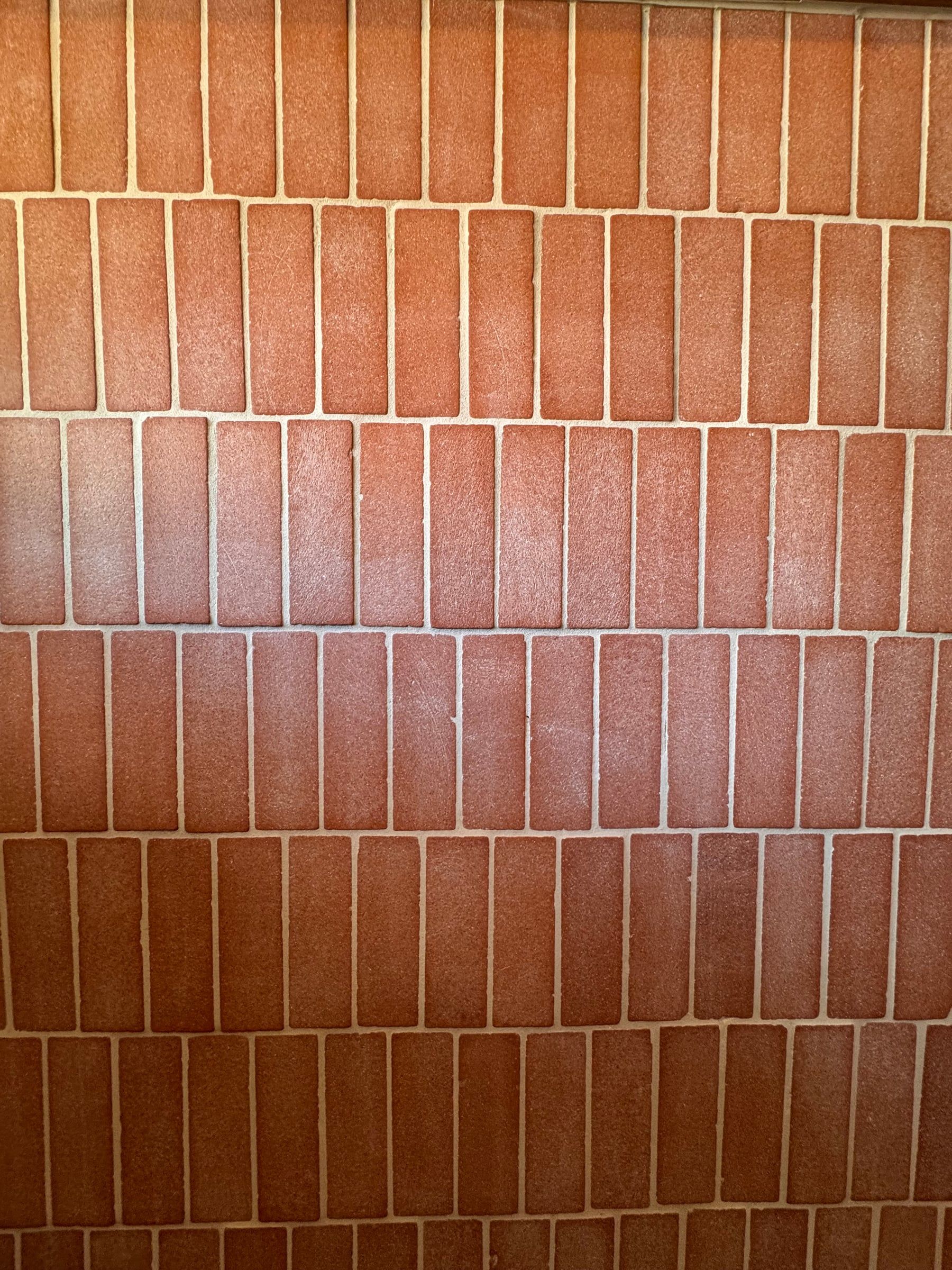 Close-up of handmade terracotta tile, laid in a vertical stack